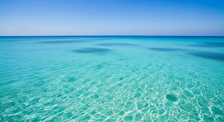 Crystal clear turquoise sea water reflecting the sunlight on a sunny day
