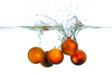 Juicy Tomatoes Splashing Into Clear Water With Bubbles And Ripples