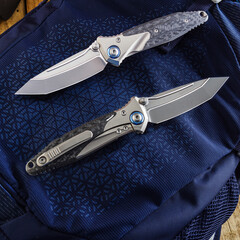 Folding EDC knife with pocket clip in open and closed position on blue background.