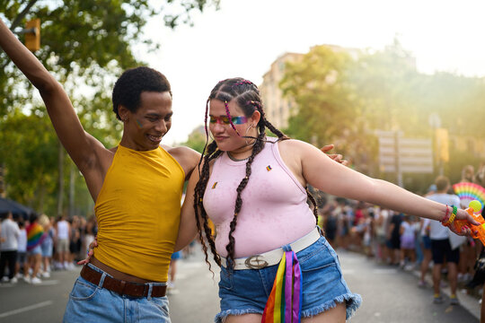Happy couple dancing together at gay pride parade celebrating lgbtq rights