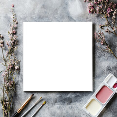 Mockup artist canvas in square format on grey table. format top view. Frame for design