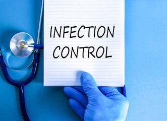 Infection control symbol. Concept words Infection control on beautiful white note. Doctor's hand in...