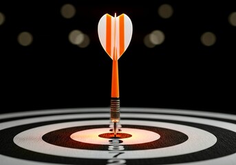 A dart with orange and white flights is perfectly hit into the center of a black and white dartboard, symbolizing precision, accuracy, and achieving goals.