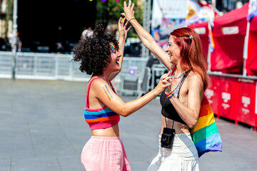 Two women celebrating love and pride at gay pride parade