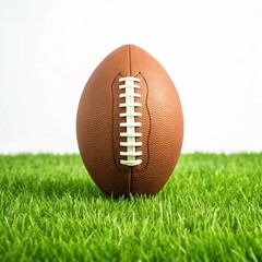 Classic american football centered on lush green grass against a white background