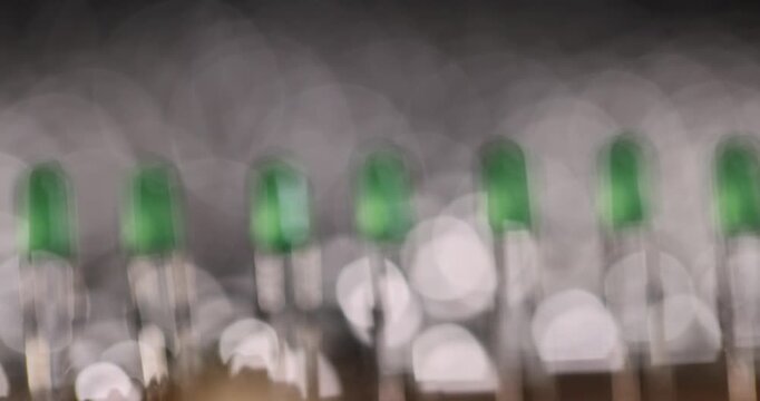 close up bulbs in a row on the printed circuit board , a large number of green light bulbs for signaling