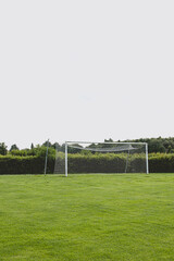 Empty soccer goal on green field