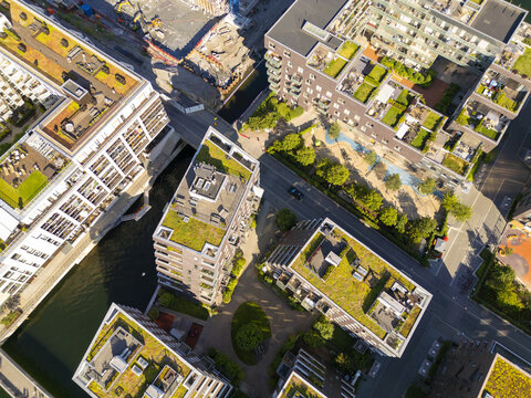 Aerial view of buildings with green roofs casting shadows over the water near the Barcode buildings, Oslo, Norway.
