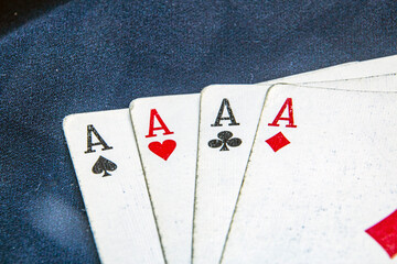 Four aces of playing cards on a dark background	
