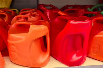 Colorful plastic containers lined up on a shelf in a store