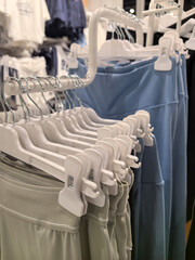 Stylish workout attire displayed on hangers in a vibrant retail space