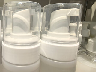 Modern pump dispensers lined up for an organized display in a store setting