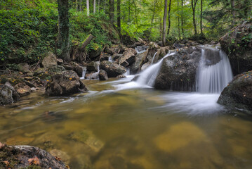 Ysperklamm, Austria: Cascading waterfall over mossy rocks in a lush, forested gorge.

