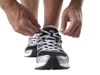 PNG Of Close-up of a male athlete tying the laces of his running shoes, focused and ready for a workout.