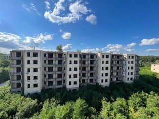 Abandoned ruins where nature has reclaimed the space.