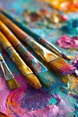 Fototapeta premium Close-up of paintbrushes on a colorful artist's palette