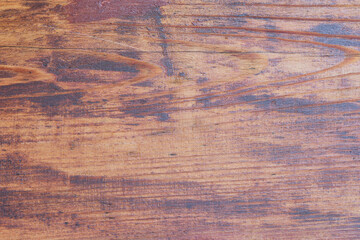 Natural wood texture showcasing rich grain patterns from a rustic tabletop during bright daylight