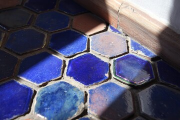 Hexagonal tiles in shades of blue and brown.