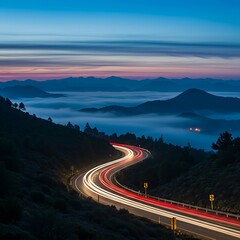 A powerful image of travel and motion, featuring a curvy road with light streaks winding through a foggy, mountainous valley.
