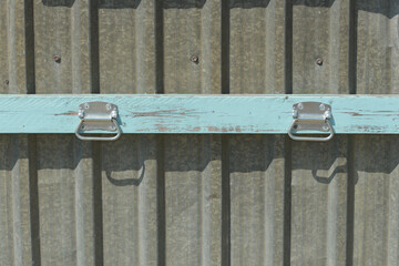 metal barn door pulls or pull handles on wood and fixed to corrugated metal siding