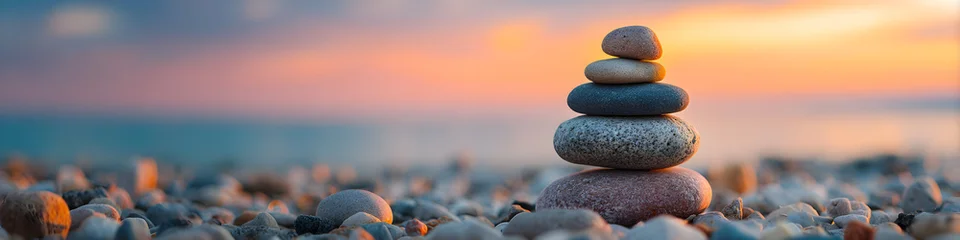 Keuken achterwand Stenen in het zand Stacked stones on a pebble beach at sunset creating a sense of balance and peace in nature  © M