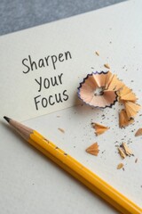 Pencil and Shavings with 'Sharpen Your Focus' Text on Paper