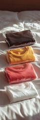 Folded Colorful T-Shirts on Bed 