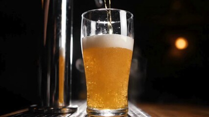 glass being filled with beer