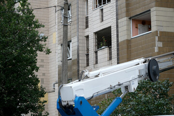 Workers performing maintenance on a high-rise building during the day