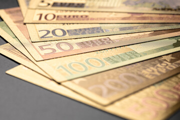 Stack of Various Euro Banknotes Arranged on a Black Background