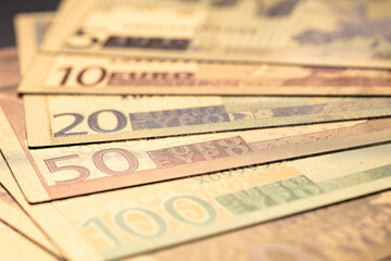 Stack of Various Euro Banknotes Arranged on a Black Background