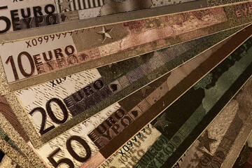Stack of Various Euro Banknotes Arranged on a Black Background