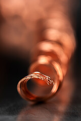 Coil of copper wire in an industrial space with shallow depth of field