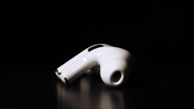 two Earpods in black background