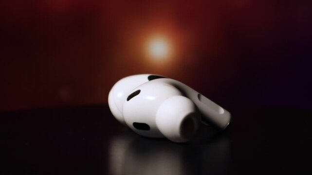 two Earpods in black background