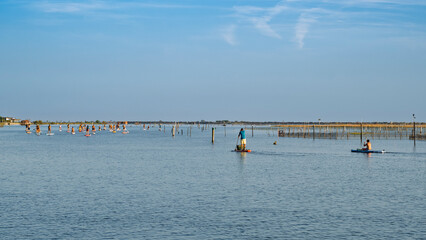 Stand Up Paddle at Porto Caleri Lagoon. Stand Up Paddle (SUP): an organized group of people...