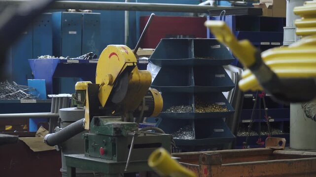 Metal cutting machine at workplace in workshop at plant near racks for storing parts. Machine building factory during break without people. Crisis and stoppage of production.