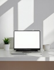 Minimalist home office desk with laptop, coffee mug, and indoor plant, natural daylight from window