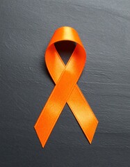 Orange ribbon on dark surface