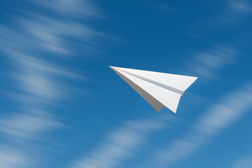White Paper Airplane in Motion Against Blue Sky with Clouds