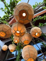 Outdoor Hanging Lanterns with Warm Light and Greenery