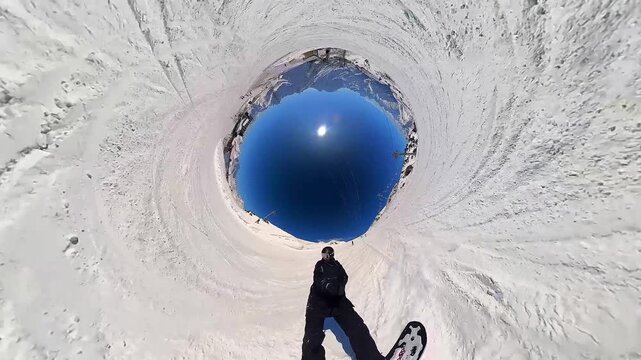 Snowboarding. A snowboarder rides down a mountain slope at a ski resort. Extreme sports and a healthy lifestyle. Pleasure and drive. Winter snow, sun and blue sky 24