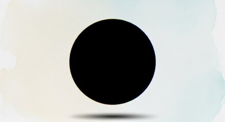 Black oval shape with a colorful halo over watercolor paper surface. Abstract design element for creative projects.