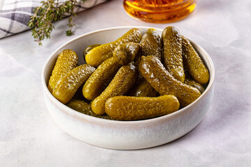 Marinated canned green cornichon cucumbers