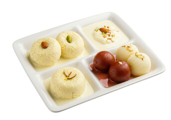 Assorted indian sweets arranged on a white compartmentalized plate with various toppings and liquid sauce on transparent background