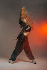 Jazz Funk Dancer Performing Dynamic Hair Flip in Urban Studio with Dramatic Lighting and Smoke