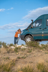 Van life girl with her son and her 4WD camper