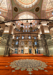 Interior view of the New Mosque, Turkish: Yeni Cami in Istanbul, Turkey. Features a richly...