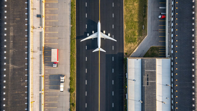 Aerial view of airplane on runway ready for takeoff at airport terminal for travel and transportation