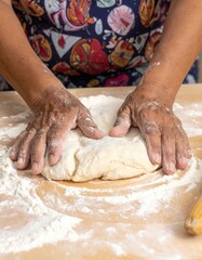 Woman Kneading Dough with White Flour on Wooden Table in Kitchen for Bread Baking